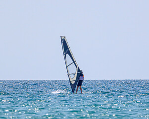 Surfing in the wind at sea.