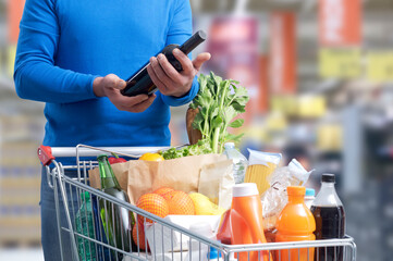 Man doing grocery shopping and buying wine