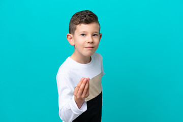 Little kid boy isolated on blue background making Italian gesture