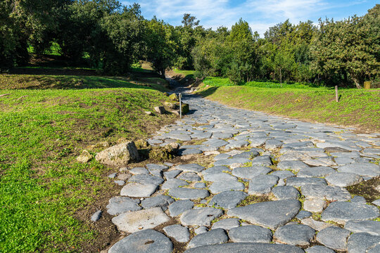 An ancient cobbled street in the Roman city of Cumae at Cumae archaeological park, Pozzuoli, Italy