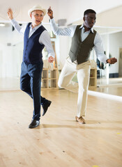 Two professional dancers practicing lindy hop in dance class