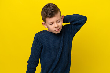 Little caucasian boy isolated on yellow background with neckache