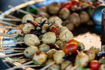 Thai meatball on wooden stick at street food market in Thailand