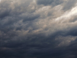 Dark gray heavy clouds in the sky before a thunderstorm. Dramatic spectacular backdrop or wallpaper. Natural grim menacing background. Ahead of a storm or cataclysm. Bad terrible weather. Overcast