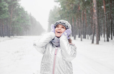 Fototapeta na wymiar Woman in snowy forest. Winter vacation.