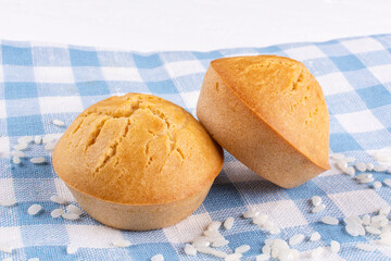 Two delicious homemade rice cupcakes with raisins close-up on a blue cloth napkin. Rice flour muffins. The concept of proper nutrition, gluten-free diet, healthy lifestyle.