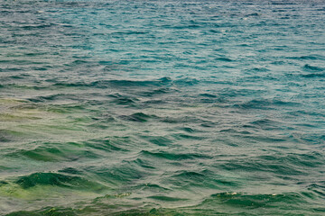 Waves on the surface of the turquoise tropical sea.