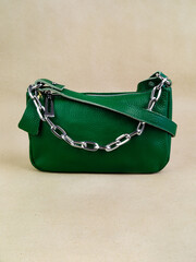 A beautiful women's bag stands on a paper background.