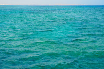 Fototapeta na wymiar The surface of the water of the Red Sea with a horizon in the background.