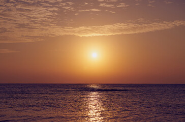 The sun rises over the Red Sea at dawn.