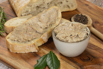 slice of bread with rillette on a wooden board