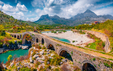 Beautiful spring view of Old Mes Bridge. Colorful morning landscape of Shkoder. Amazing outdoor scene of Albania, Europe. Traveling concept background. - obrazy, fototapety, plakaty