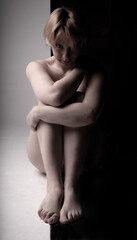 The girl sits without clothes, naked on a black and white background a beautiful blonde of European appearance Adult attractive background beautiful body, In the afternoon caucasian fashion from fresh