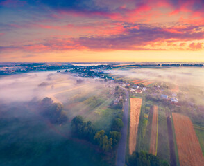 Exciting summer dawn on Ukrainian countryside with foggy fields. splendid morning view of outskirts of Ternopil town, Ukraine, Europe. Greenery concept background.