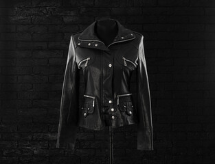 black leather jacket with studs on a black background