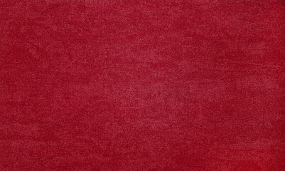 textured background surface of red textile upholstery wallpaper in close-up view. red color fabric structure detail. macro of a woolen cloth texture.