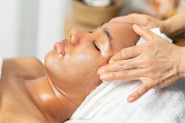 Zelfklevend Fotobehang Badkamer Close-up portrait of a young woman getting spa treatment and face massage at beauty salon. Facial beauty treatment concept   © supAVADEE BUTRADEE
