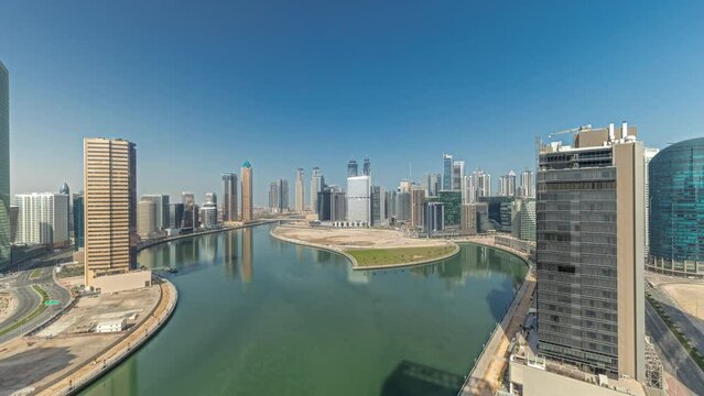 Cityscape skyscrapers of Dubai Business Bay with water canal aerial timelapse.