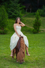 Fototapeta premium girl riding a pony in the park