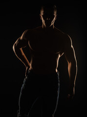 Fototapeta na wymiar Portrait of topless guy posing and standing, silhouette