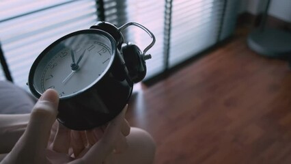 Setting clock back by 24 hours in room by women hand 4k