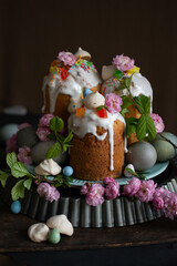 Dark Easter. Easter cakes and eggs with flowers. tulips, spring blooming