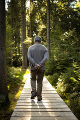 Senior man enjoying the outdoors, hiking, walking throught lovely nature