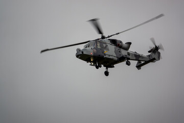 British army AgustaWestland AW159 Wildcat AH1 helicopter flying on military training exercises, Wiltshire UK