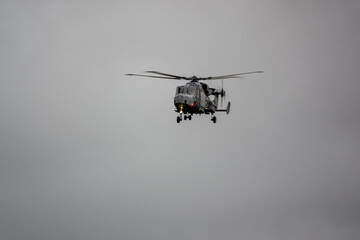 British army AgustaWestland AW159 Wildcat AH1 helicopter flying on military training exercises, Wiltshire UK