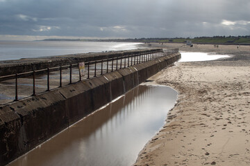 Fototapeta na wymiar Sea defences/wall barrier with views looking towards the beach at Gorleston-on-sea in Norfolk, UK