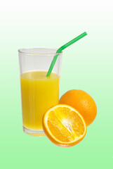 Two oranges and a glass of orange juice on a green background.