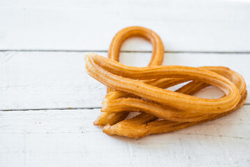 Several churros, typical Spanish churros, are made with flour, water, salt and oil, prepared in churrerías,