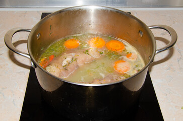 cooking broth from pork knuckle with vegetables. Preparation for jelly from pork meat