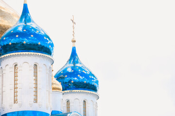 Blue and golden domes of white orthodox church