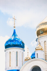 Blue and golden domes of white orthodox church