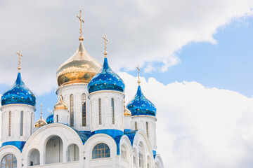Blue and golden domes of white orthodox church