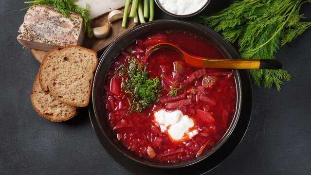 Traditional Ukrainian Russian borscht . Bowl of red beet root soup borsch with white cream . Beet Root delicious soup . Traditional Ukraine food cuisine