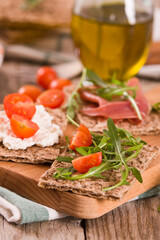 crispy rye bread with sesame seeds, ham and cottage cheese.