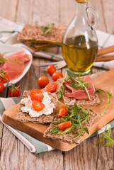crispy rye bread with sesame seeds, ham and cottage cheese.