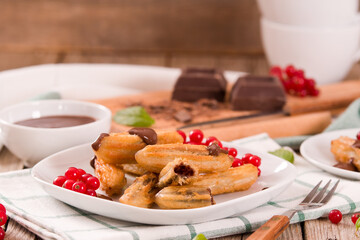 Mini churros with chocolate dipping sauce.