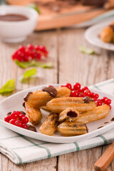 Mini churros with chocolate dipping sauce.