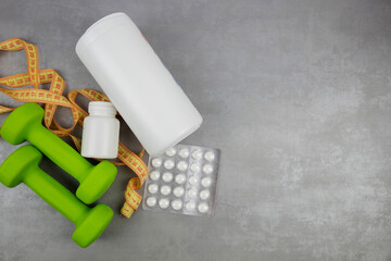dumbbells on the background of pills. Healthy lifestyle. sports nutrition, doping