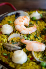 Delicious paella on the terrace with shrimp and white wine