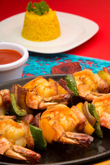 Gourmet shrimp skewers with green, red and yellow bell peppers