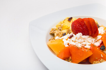 Plate of nutritious fruits for breakfast on white background