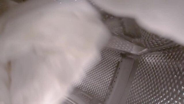 White laundry being washed in the washing machine