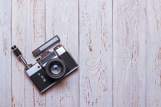 An old retro camera with a self-timer and a rangefinder lies on the table