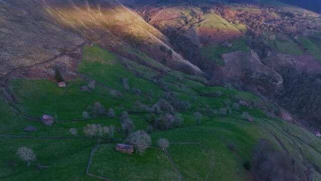 Winter landscape of meadows and cabins from Pas seen from a drone. Pasiegos Valleys between Selaya and San Roque de Riomiera. Cantabria, Spain, Europe
