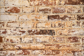 Old brick wall smeared with paint