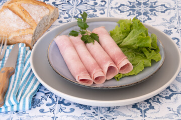 slice of white ham in a plate on a table